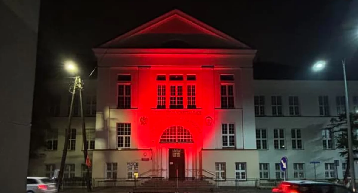 Na znak sprzeciwu wobec krzywdzenia dzieci rozświetlili na czerwono główne wejście do szkoły