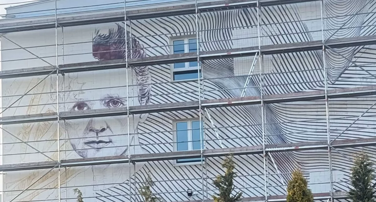 Mural Marii Skłodowskiej-Curie w Brzegu Dolnym. Łukasz Czykiel znów maluje na SP nr 5