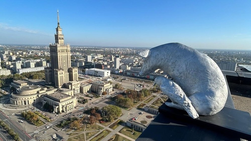 Rzeźba Idy Karkoszki patrzy na panoramę stolicy z krawędzi dachu warszawskiego Hotelu Marriott